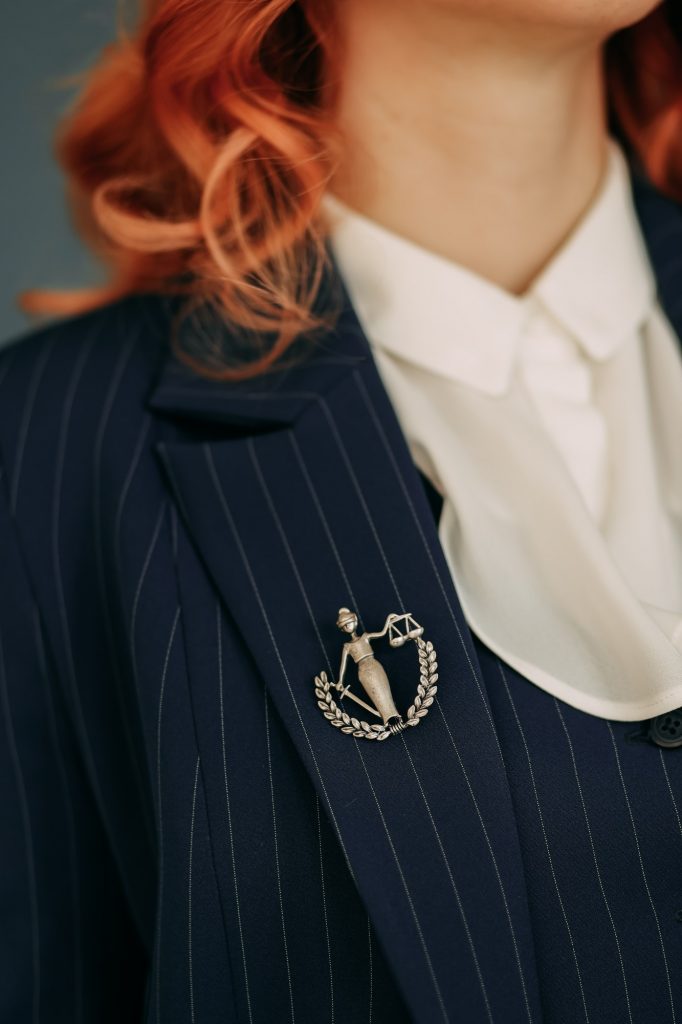 Law; lawyer; justice; confidence; work; brooch; goddess of justice; woman; large; shirt; jacket; tru